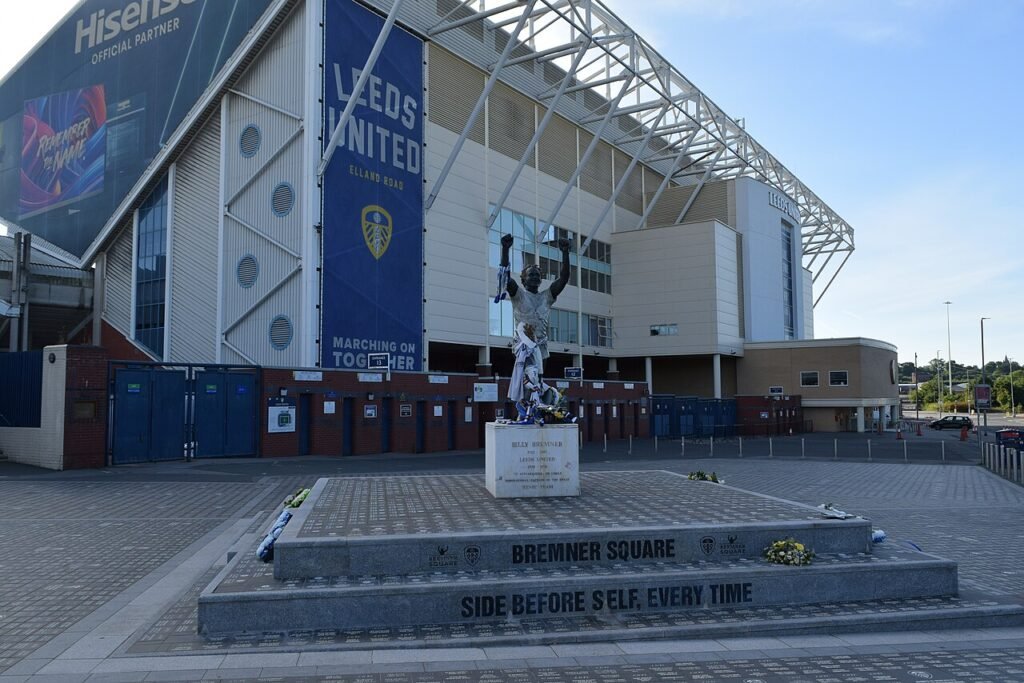 Billy Bremner statue outside Elland Road, 12 July 2025. Mtaylor848 / Wikimedia Commons, CC BY-SA 4.0 (https://creativecommons.org/licenses/by-sa/4.0/). Dated exterior landmark; follow your ticket and current access notices, especially around redevelopment works. Resized Wikimedia preview. · Elland Road
